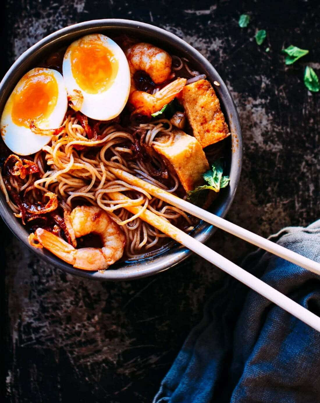 Runny egg in a bowl of noodles.